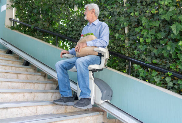 stairlift installer - Man Using Automatic Stair Lift