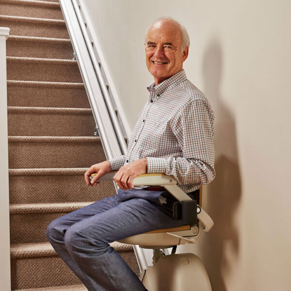 Senior using a reconditioned stairlift in a modern Leeds home
