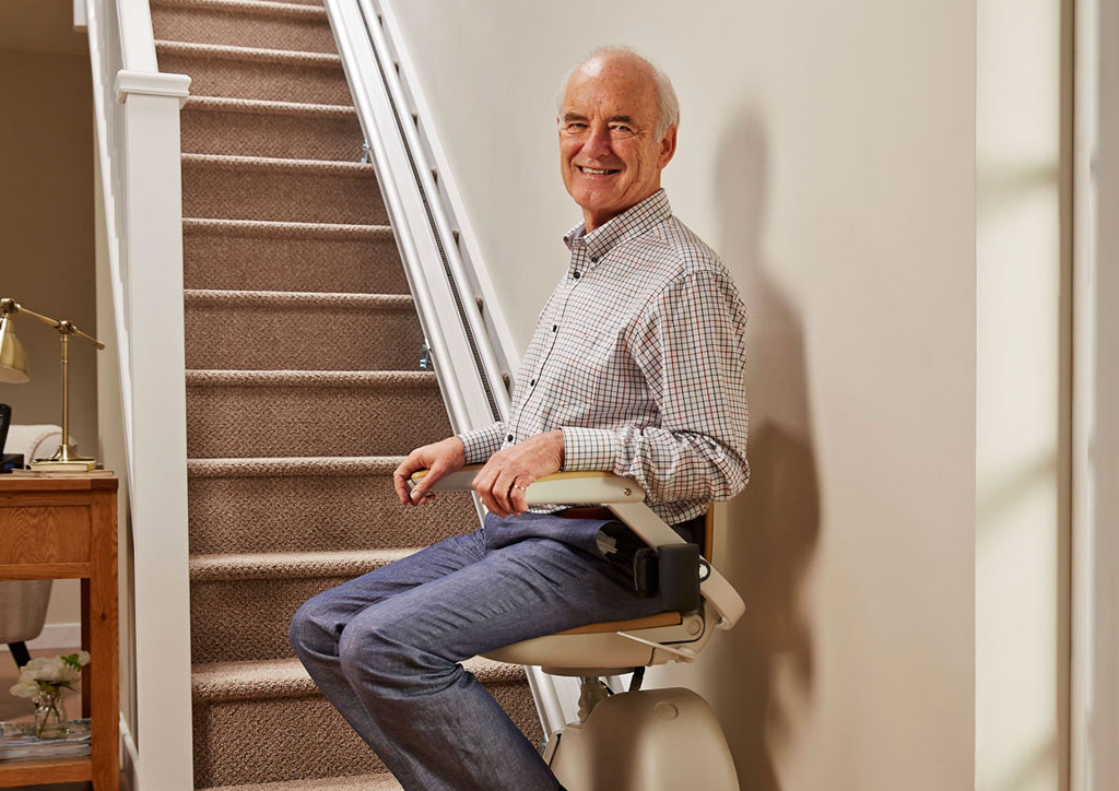 Senior using a reconditioned stairlift in a modern Leeds home